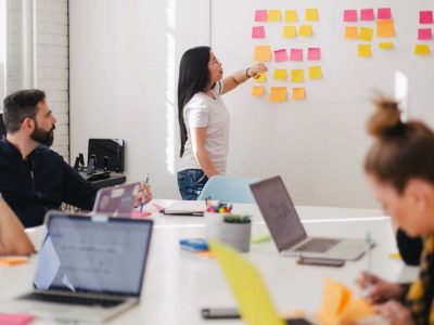 Women mentoring showing her notes to her colleagues