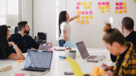 Women mentoring showing her notes to her colleagues