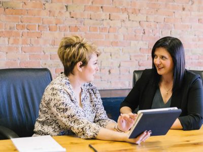 Business Meeting, two ladies sat at a table talking