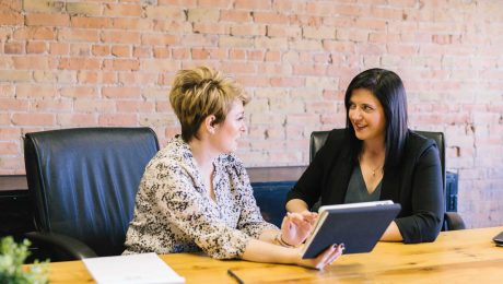 Business Meeting, two ladies sat at a table talking