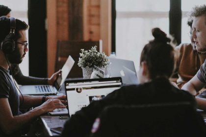 Employees working surrounding a table