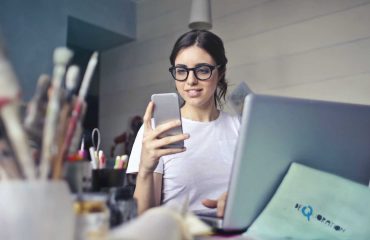 Office worker looking at her phone