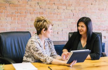 Business Meeting, two ladies sat at a table talking