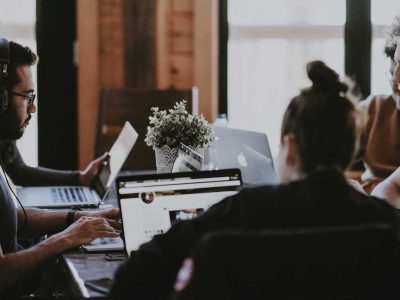 Employees working surrounding a table