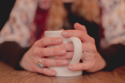 Hands holding a mug