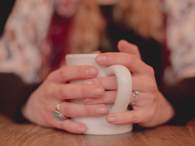 Hands holding a mug