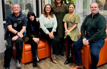 The BusinessLodge Stoke team photographed in a bright co-working space as they are recognised for Excellence in Customer Service