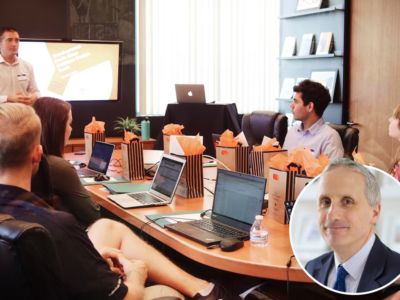 Meeting held round a table with laptops and goody bags