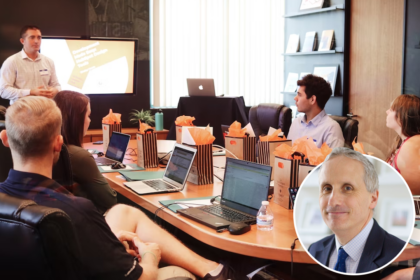 Meeting held round a table with laptops and goody bags