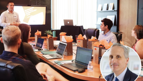 Meeting held round a table with laptops and goody bags