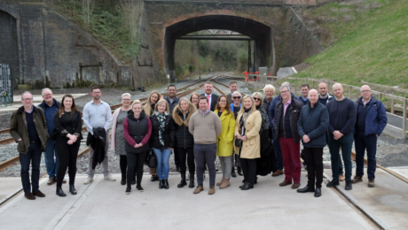 Group of Patrons pictured on a railway track smiling