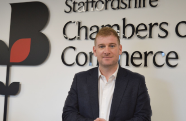 Chris Plant photographed in front of Staffordshire Chambers of Commerce's Logo