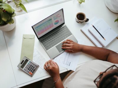 A woman working at a laptop.