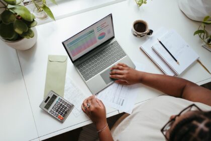 A woman working at a laptop.