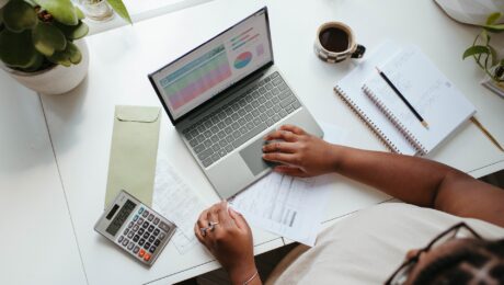 A woman working at a laptop.