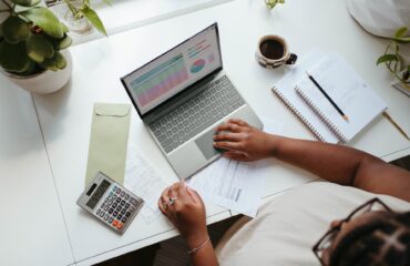 A woman working at a laptop.