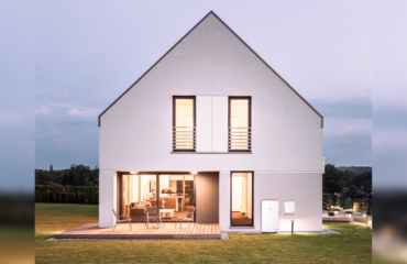 Picture of a lit-up house surrounded by a field