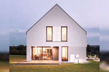 Picture of a lit-up house surrounded by a field