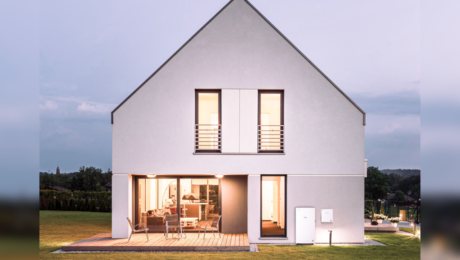 Picture of a lit-up house surrounded by a field