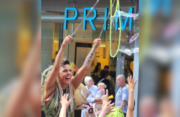 A women demonstrating how to make a bubble in front of Primark