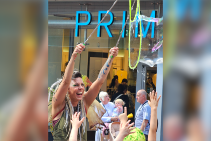 A women demonstrating how to make a bubble in front of Primark