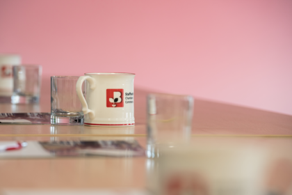 Staffordshire Chambers mug sat on a desk with other glasses for a meeting