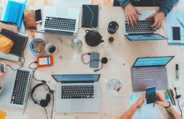 People working at desk on laptops