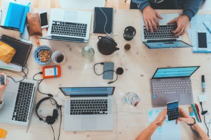 People working at desk on laptops