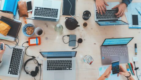 People working at desk on laptops