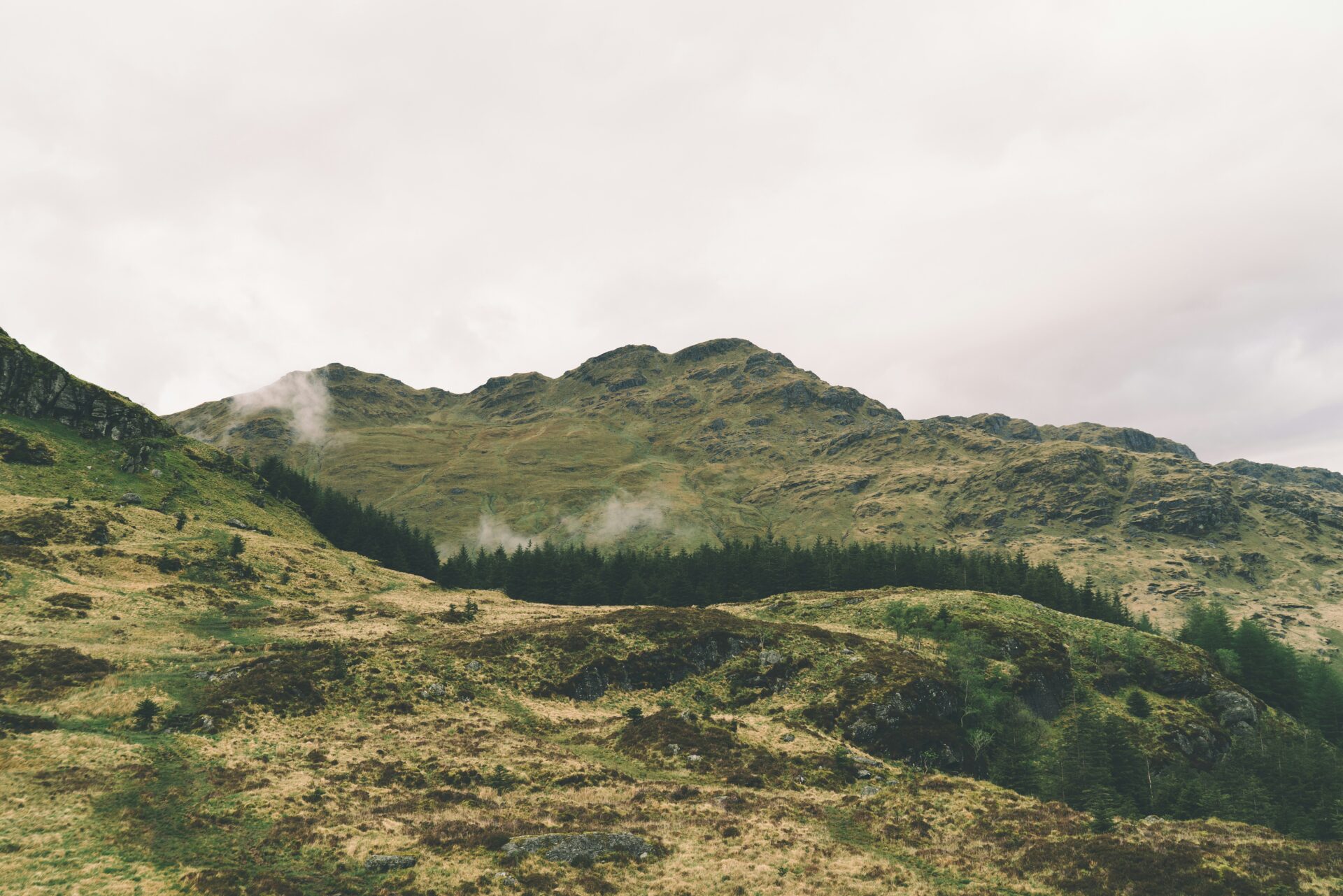 Picture of a mountain and some hills in nature.