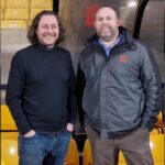 Picture of 2 plumbers/engineers standing together.