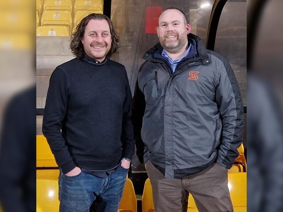 Picture of 2 plumbers/engineers standing together.