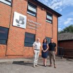 Picture of 3 people outside the Staffordshire chambers of commerce building.