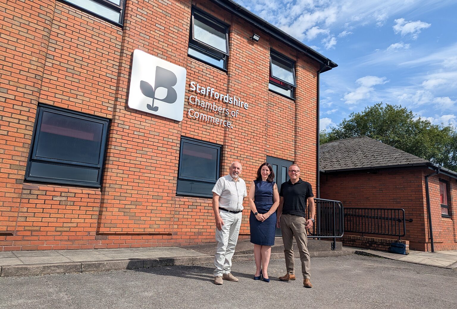 Picture of 3 people outside the Staffordshire chambers of commerce building.