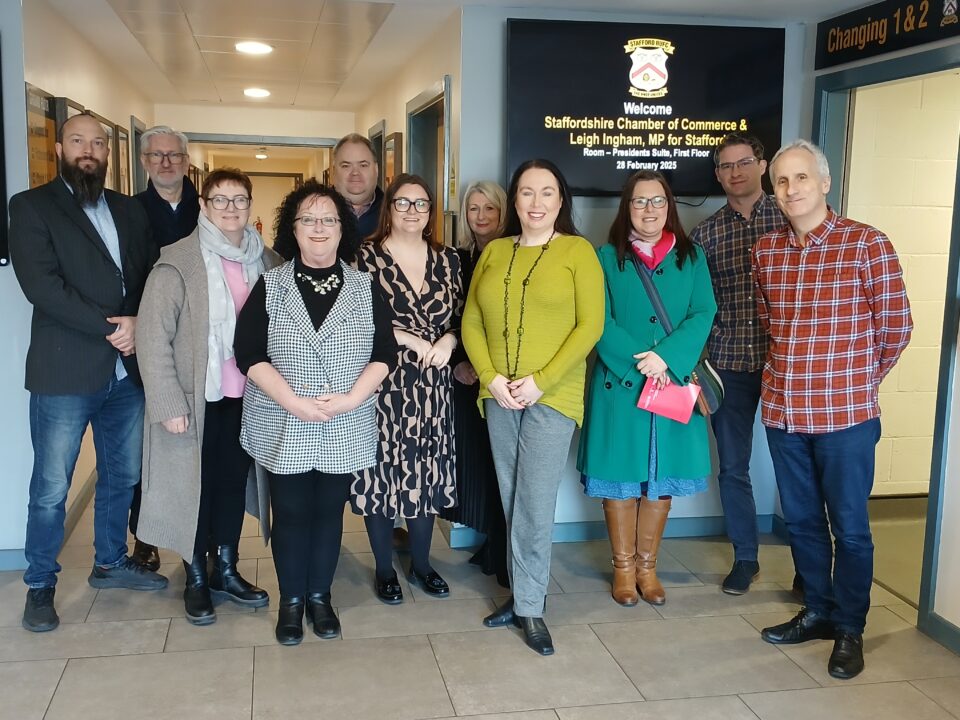 Picture of people at a meeting with connecting businesses with political leaders.