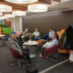 Picture of people sat around a table at the chambers members lounge.
