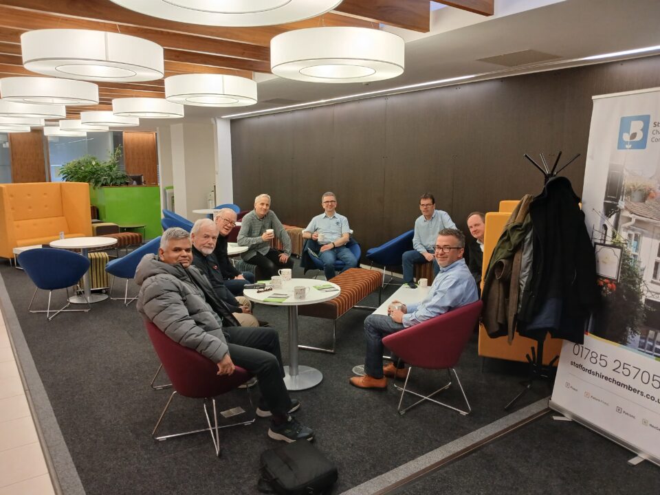 Picture of people sat around a table at the chambers members lounge.