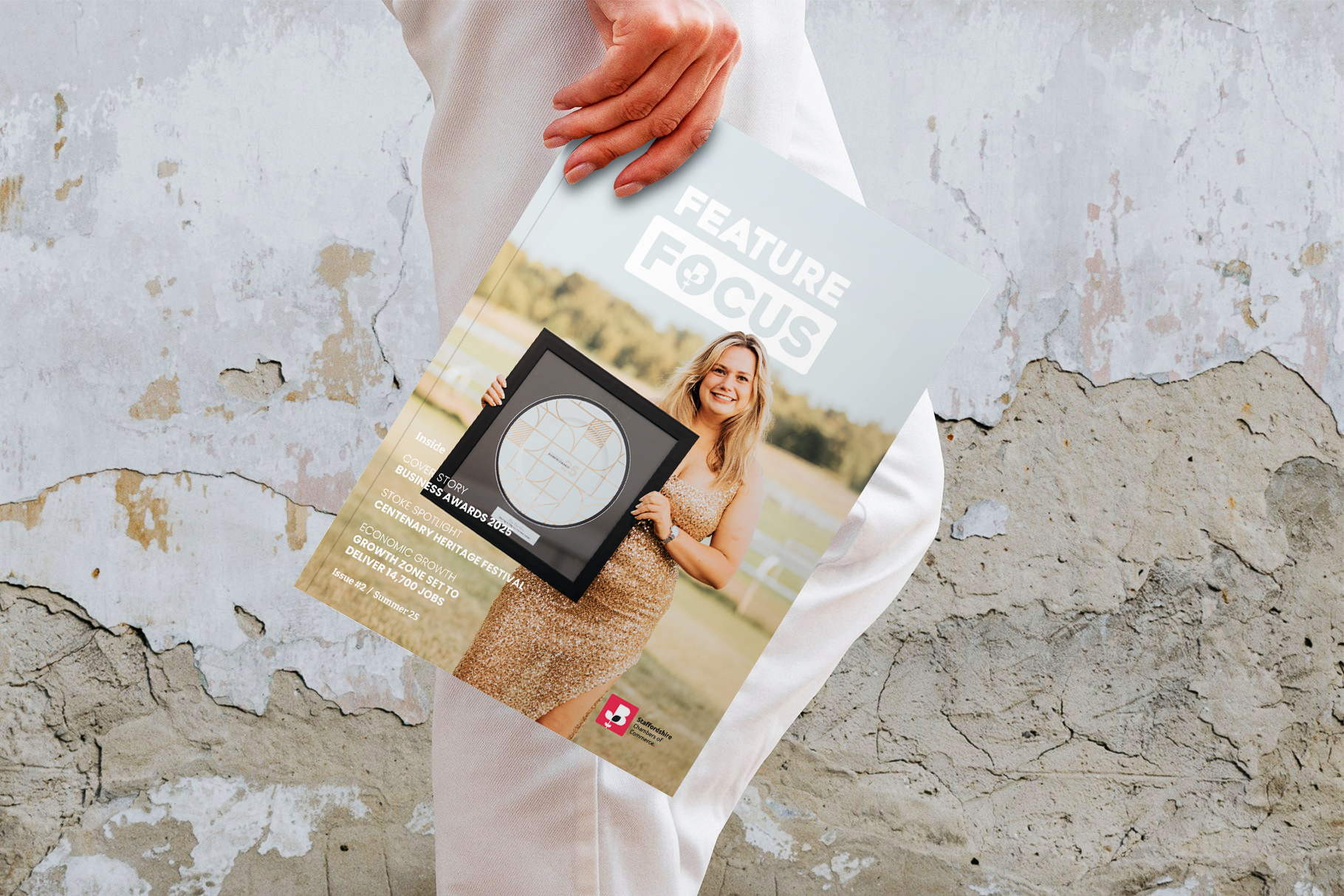 Picture of someone holding a feature focus newsletter for business awards 2025.