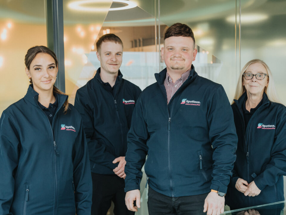 Picture of employees at spotless standing together.