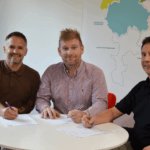 Picture of Chris Plant with chamber partner AMB insurance signing papers.