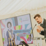A person talking on podium at Staffordshire chambers of commerce expo event