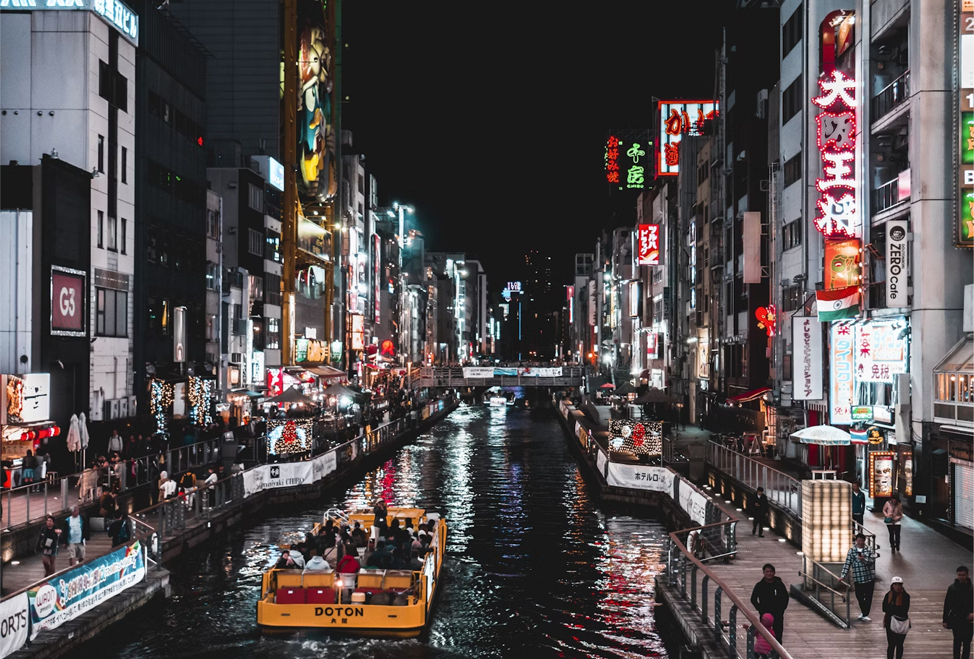 Picture of Japan, City life with shops on either side of a Canal, with a car boat driving ahead.