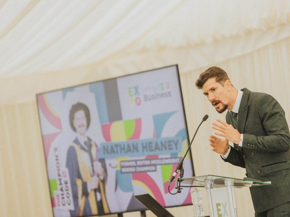 A person talking on podium at Staffordshire chambers of commerce expo event