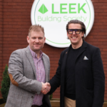 Andy Deeks and Chris plant shaking hands Infront of leek building society logo.