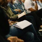 Picture of a group of people at an event taking notes.
